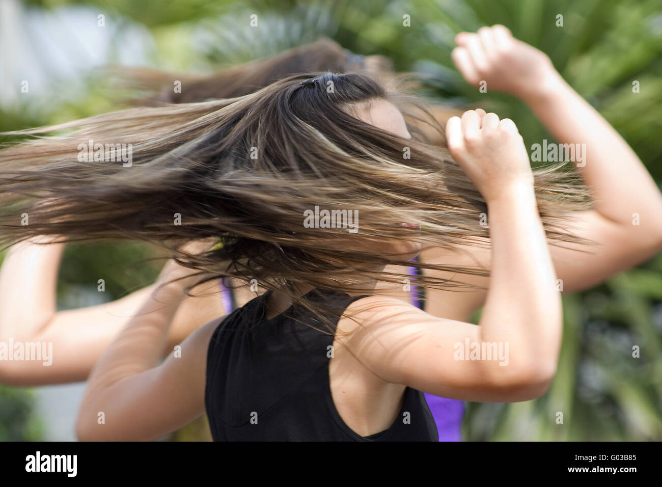 Young female dancers with streaming hairs Stock Photo