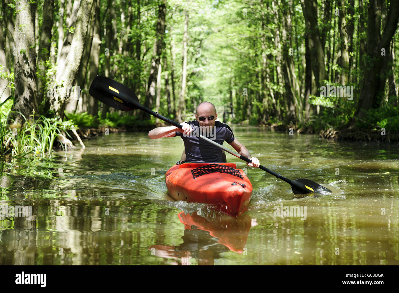 young man in the red paddle boat in the Spree Fore Stock Photo