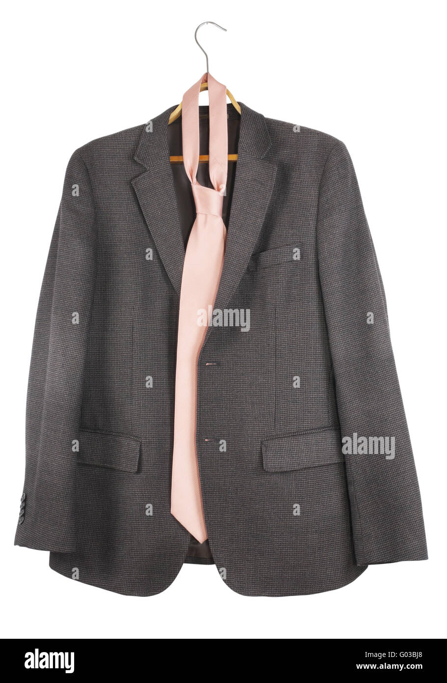 The old shabby tweed jacket and pink tie hang on a hanger Stock Photo