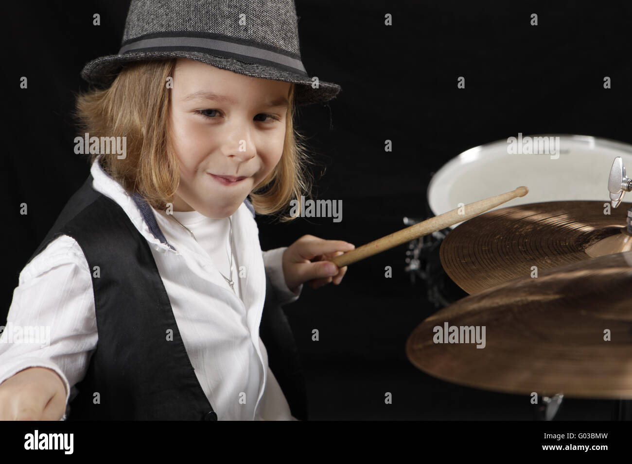 little boy is playing ambitiously the drums Stock Photo - Alamy