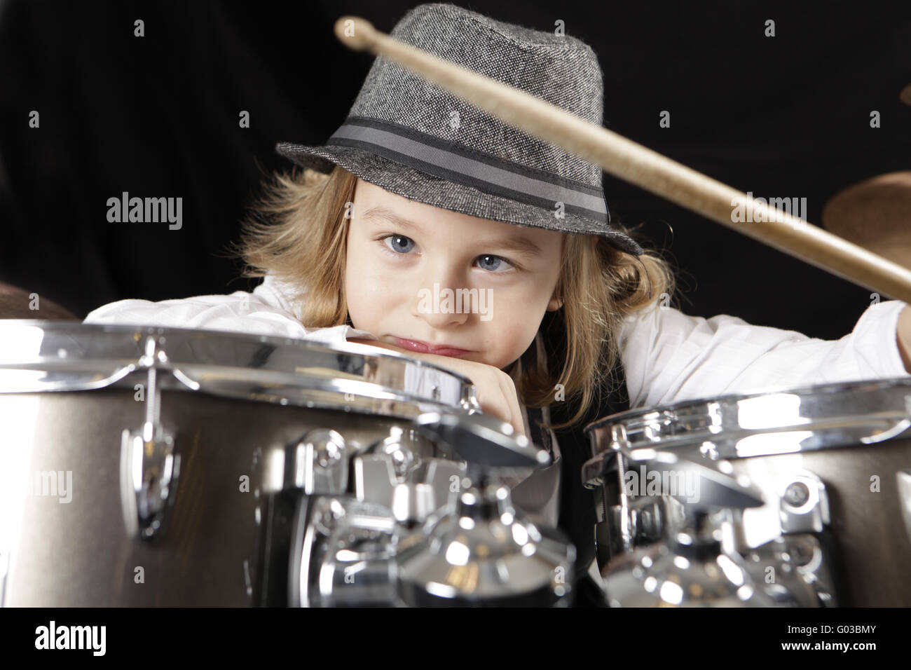 young boy is not motivated to play the drums Stock Photo