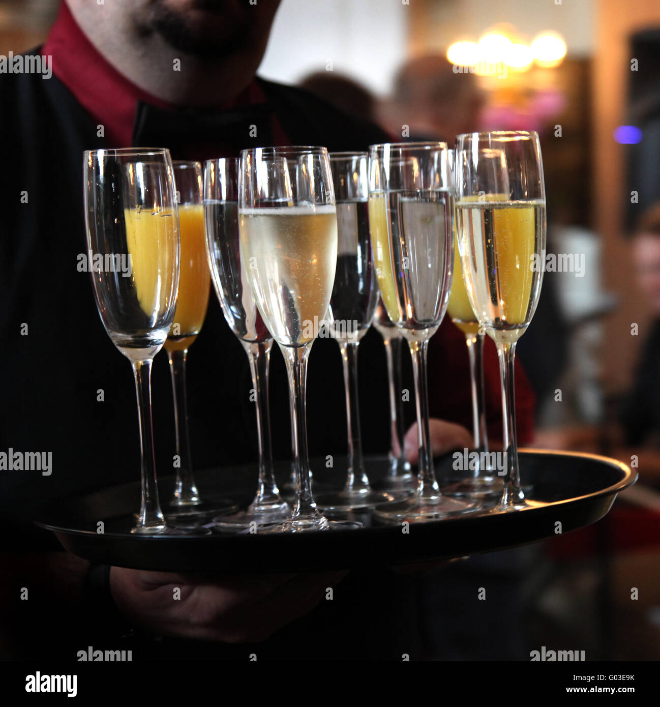 Waiter serving tray with sparkling wine and Champa Stock Photo