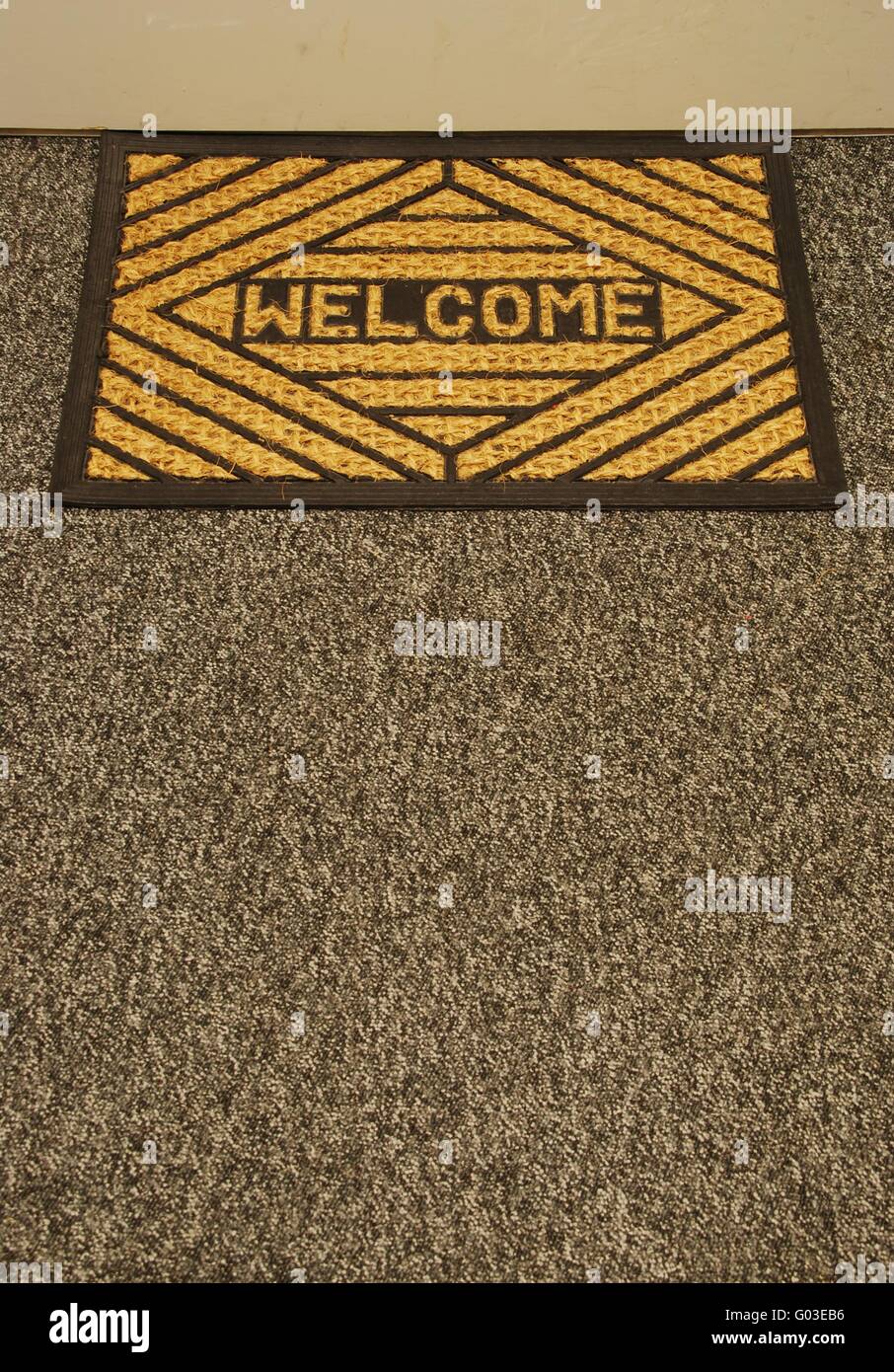 beautiful home door mat on a grey carpet Stock Photo Alamy