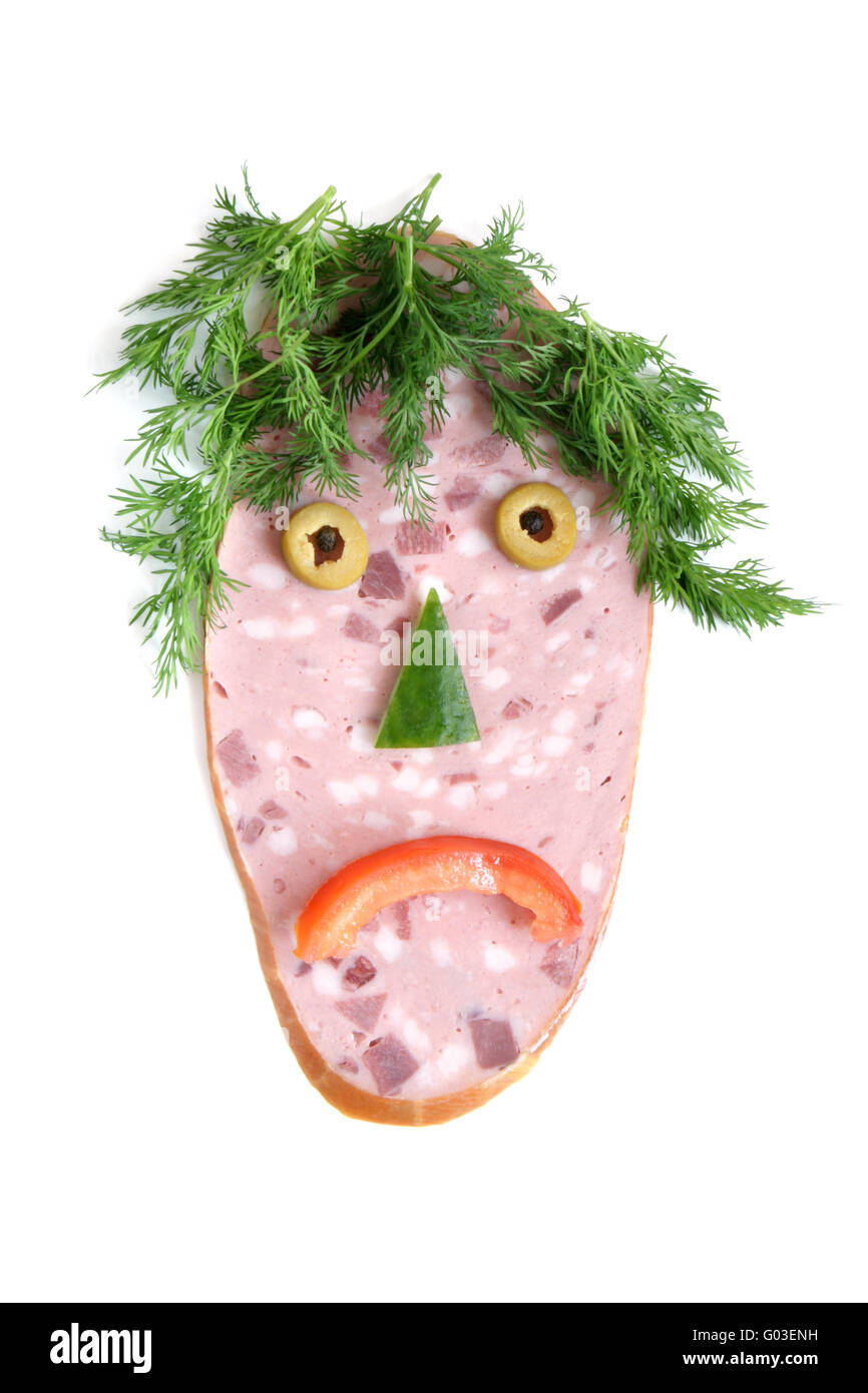The cut sausage and vegetables in the shape of a sad face Stock Photo