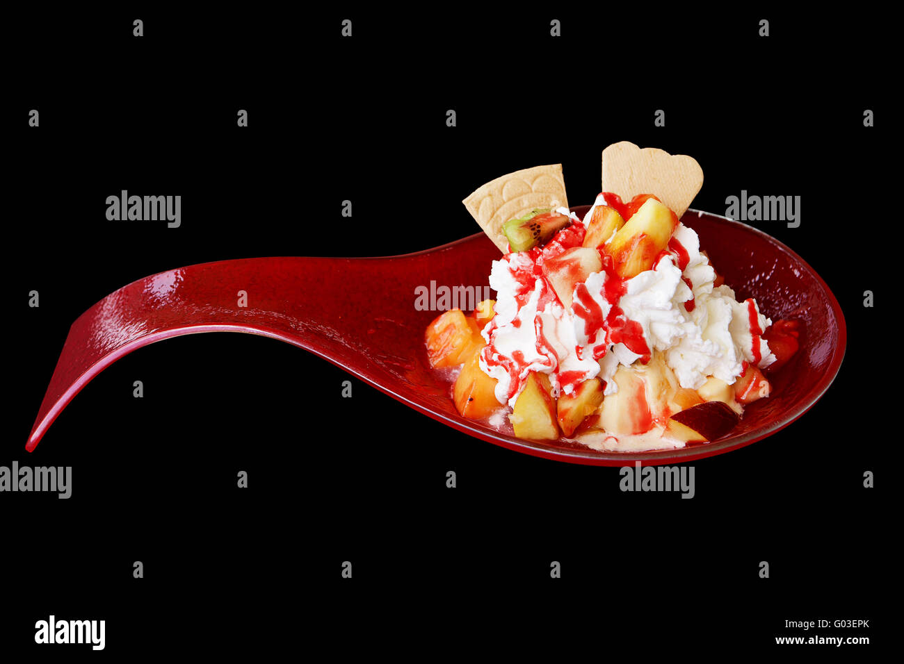 Ice-cream with fruit, cookies in a red spoon Stock Photo