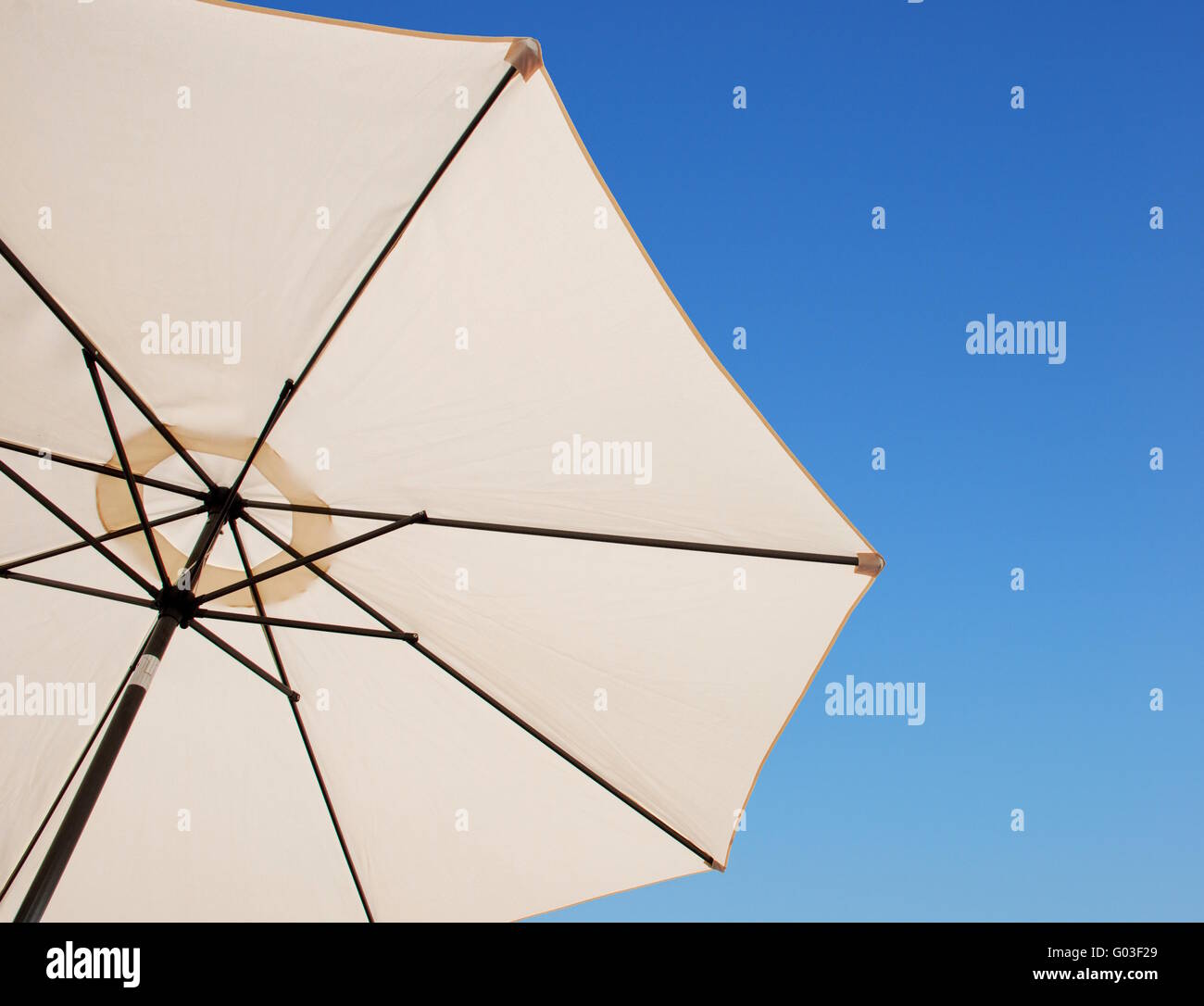 beach or pool outdoor umbrella against a gorgeous blue sky background Stock Photo