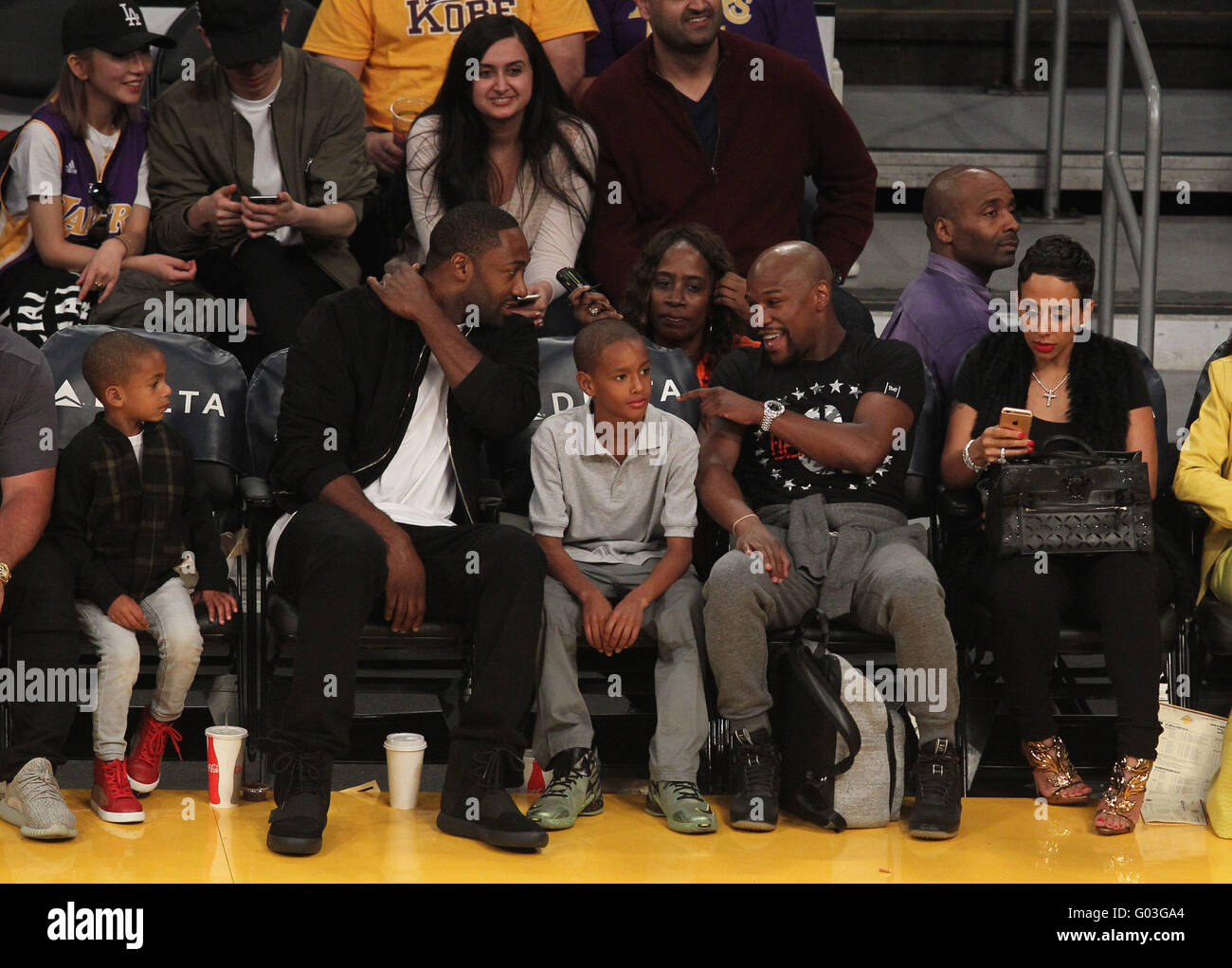 Basketball player Gilbert Arenas, left, talks with Floyd Mayweather, Jr.,  right, during the second half of an NBA basketball game between the Los  Angeles Lakers and the Washington Wizards, Sunday, March 27