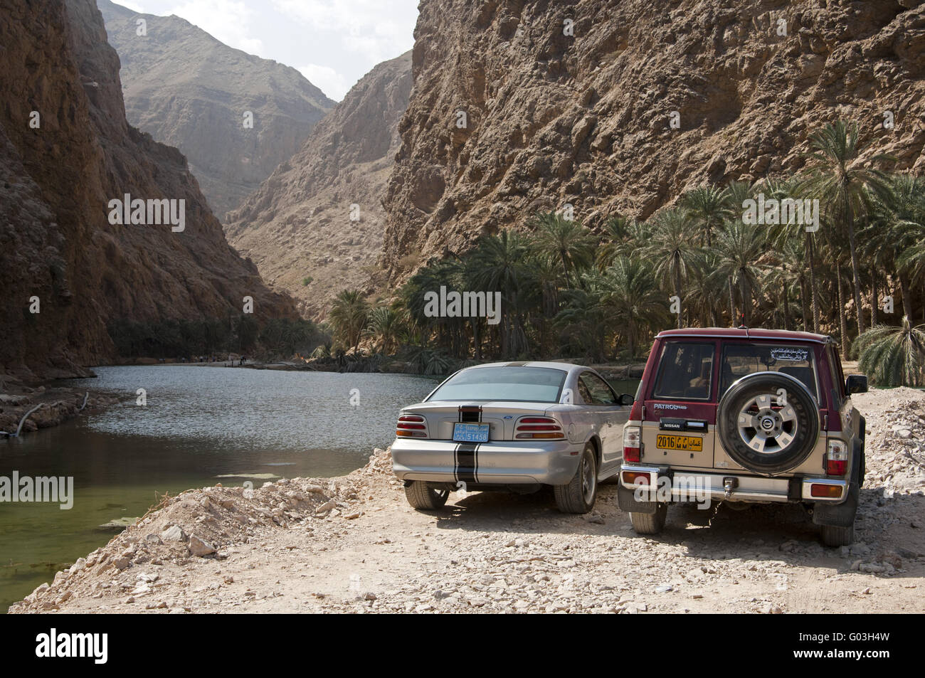 vehicles parking at the entrance to the Wadi Shab Stock Photo