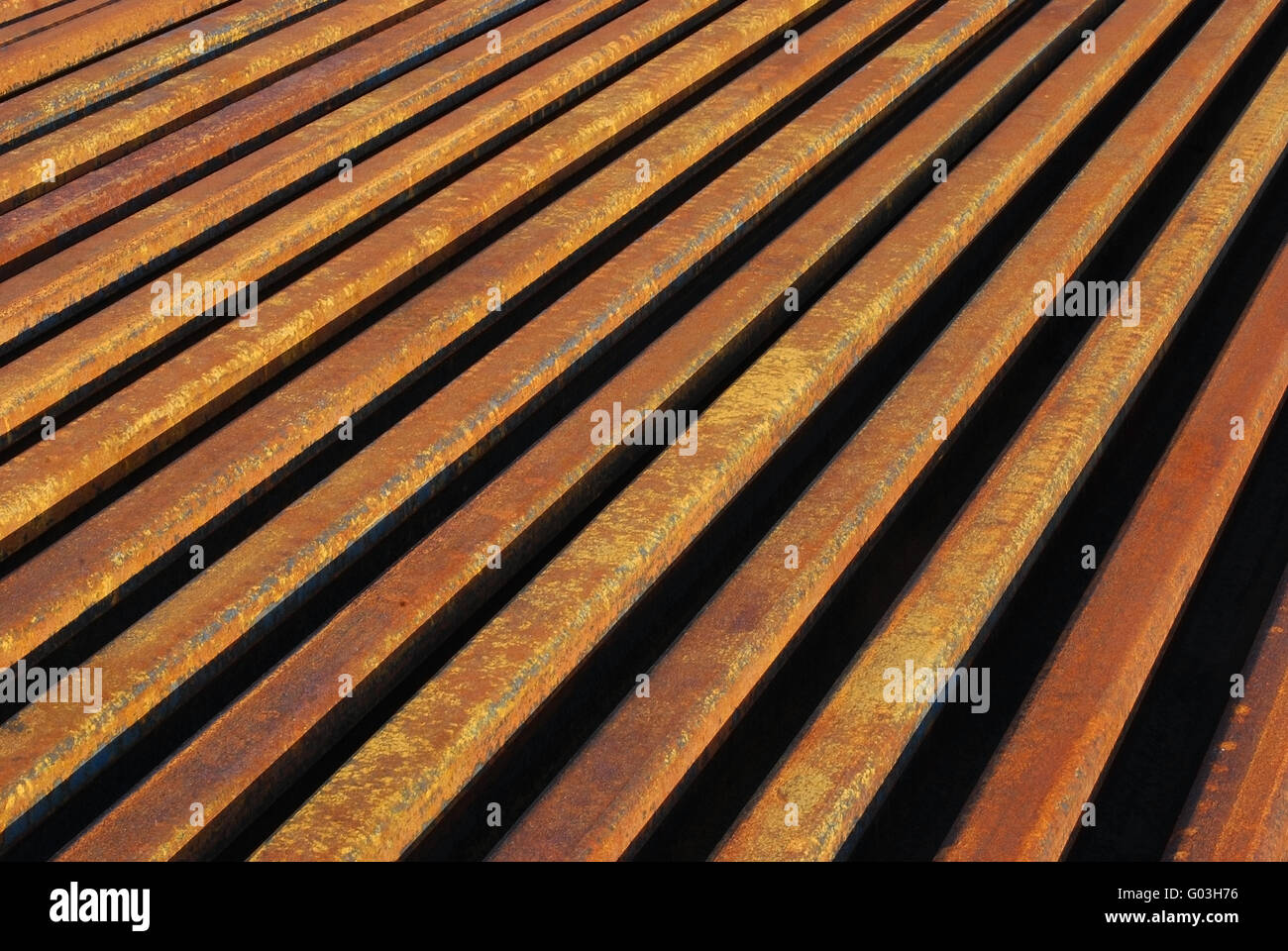 Rusty rails lined-up close as background perspecti Stock Photo - Alamy