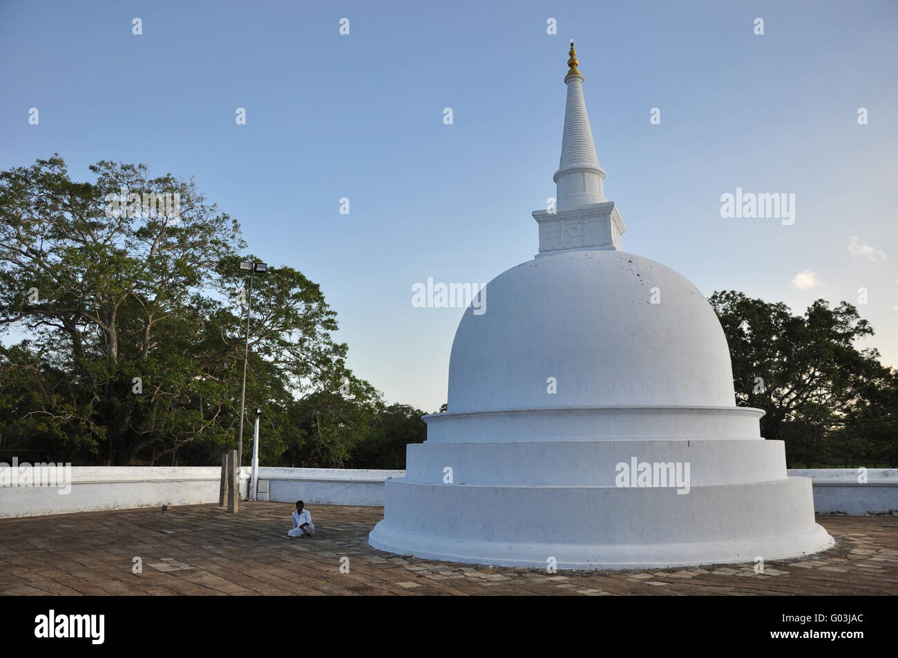 small Dagoba with sitting monk Stock Photo