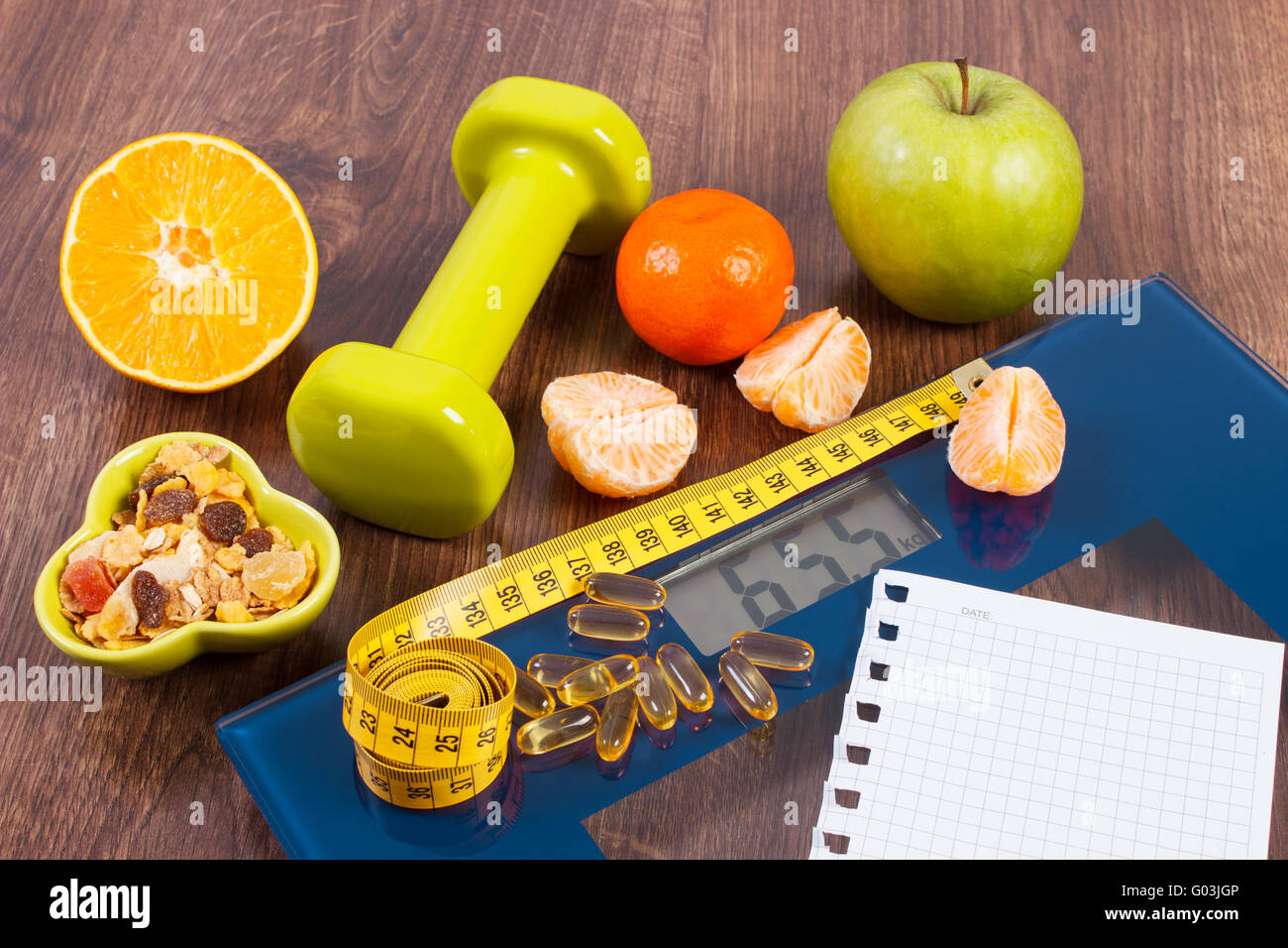 Bathroom scale and coiled tape measure for losing weight to be thinner  Stock Photo - Alamy