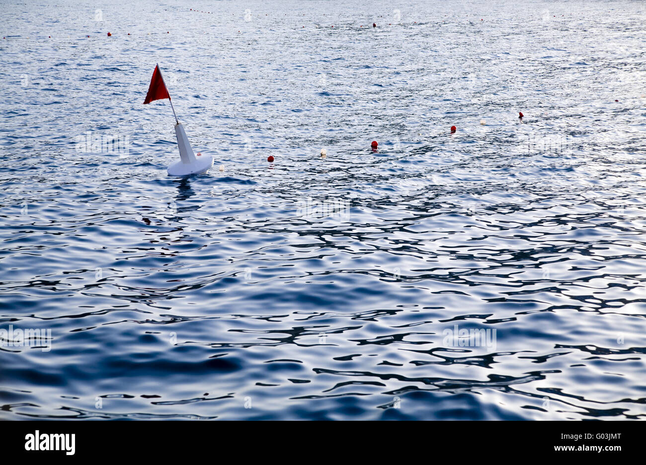 navigation buoy in sea water near a coasline Stock Photo