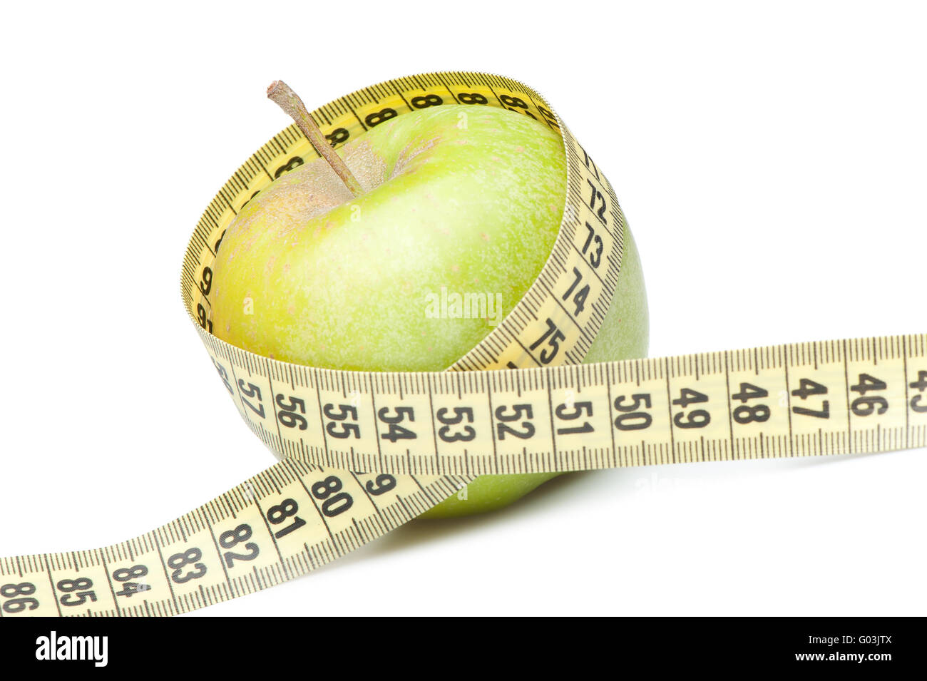 Closeup of a green apple with a measuring tape. Isolated on white Stock Photo