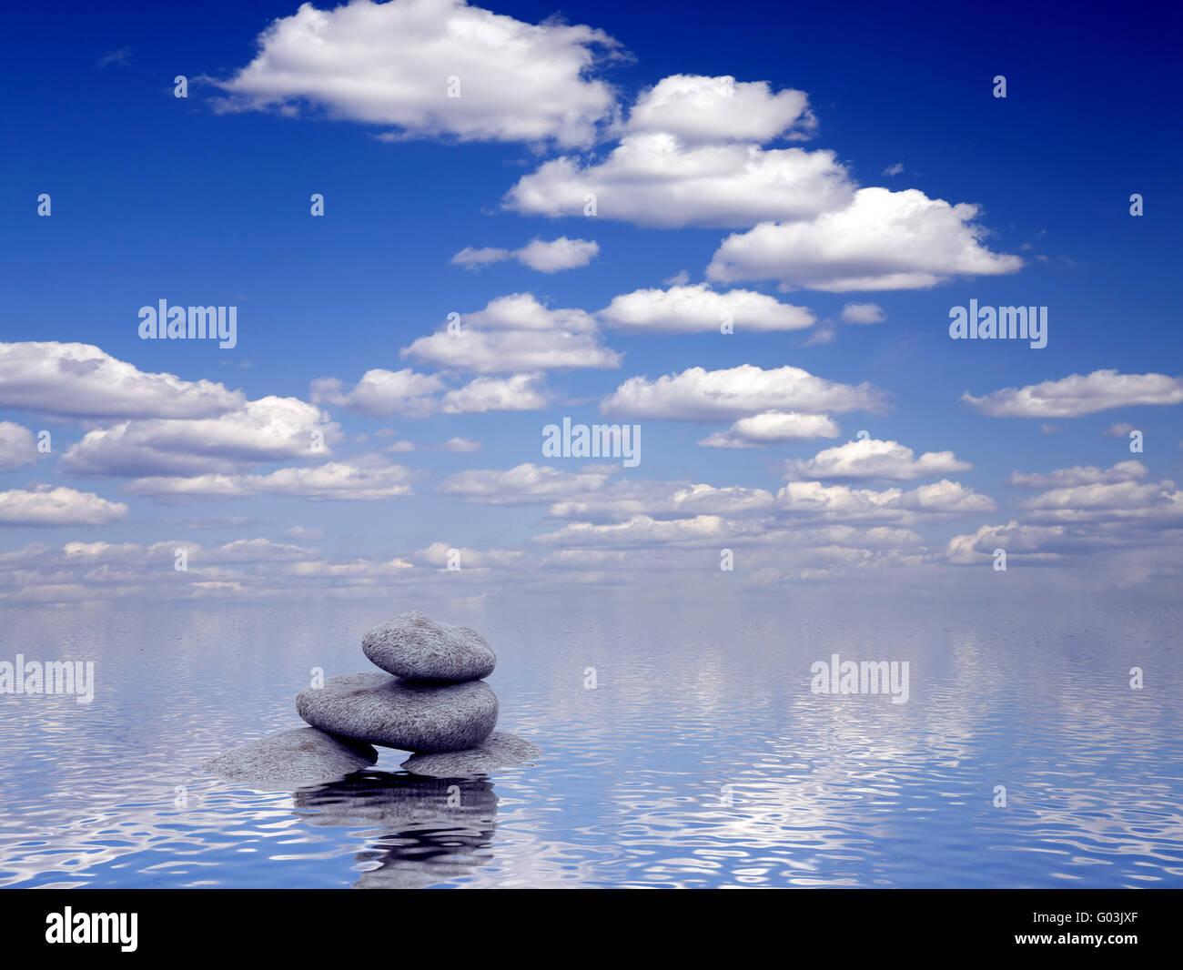 stones in water on a background bright blue sky Stock Photo