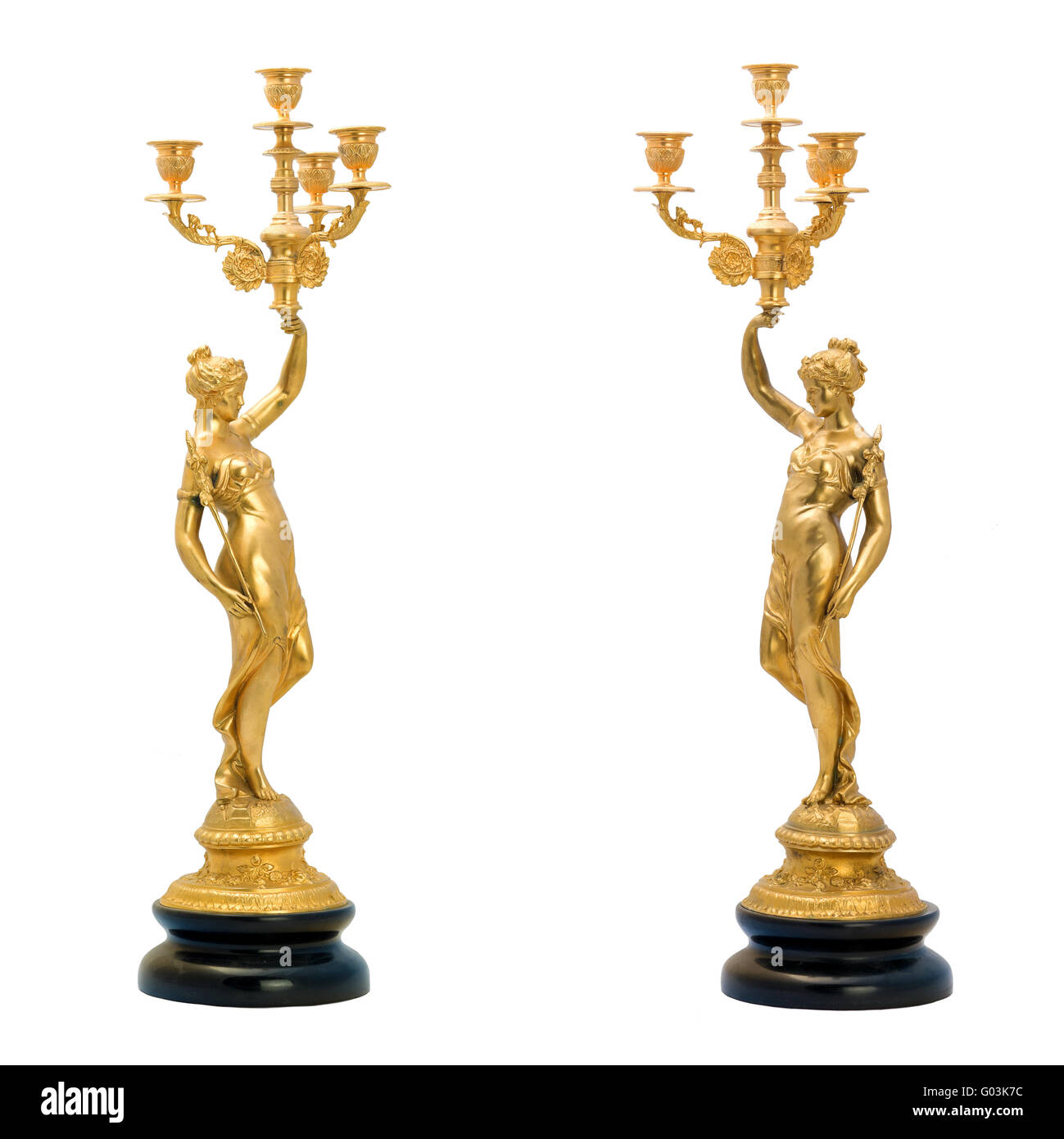 Two antique gold candlestick in the form of female figurines. Stock Photo