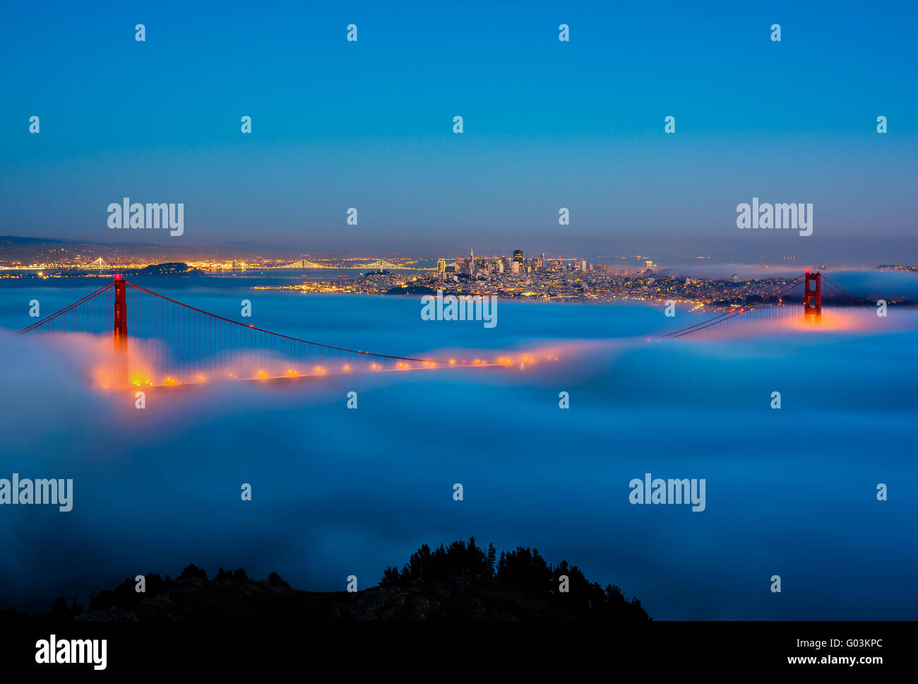San Francisco and Golden Gate Bridge on a foggy night Stock Photo