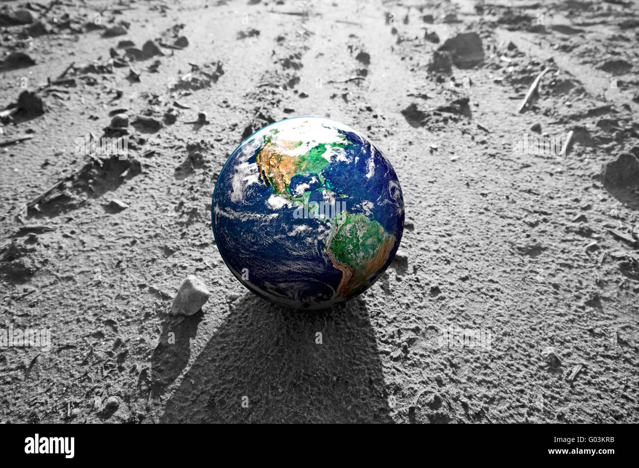 The Earth globe on rocky Mars like surface. Concepts of Earth protection Stock Photo