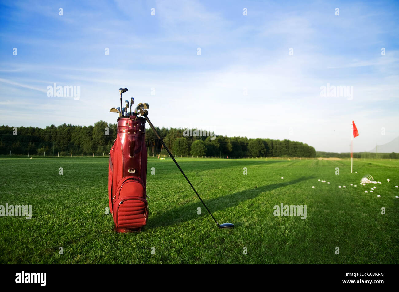 Golf gear on the golf field. Red flag in the background Stock Photo