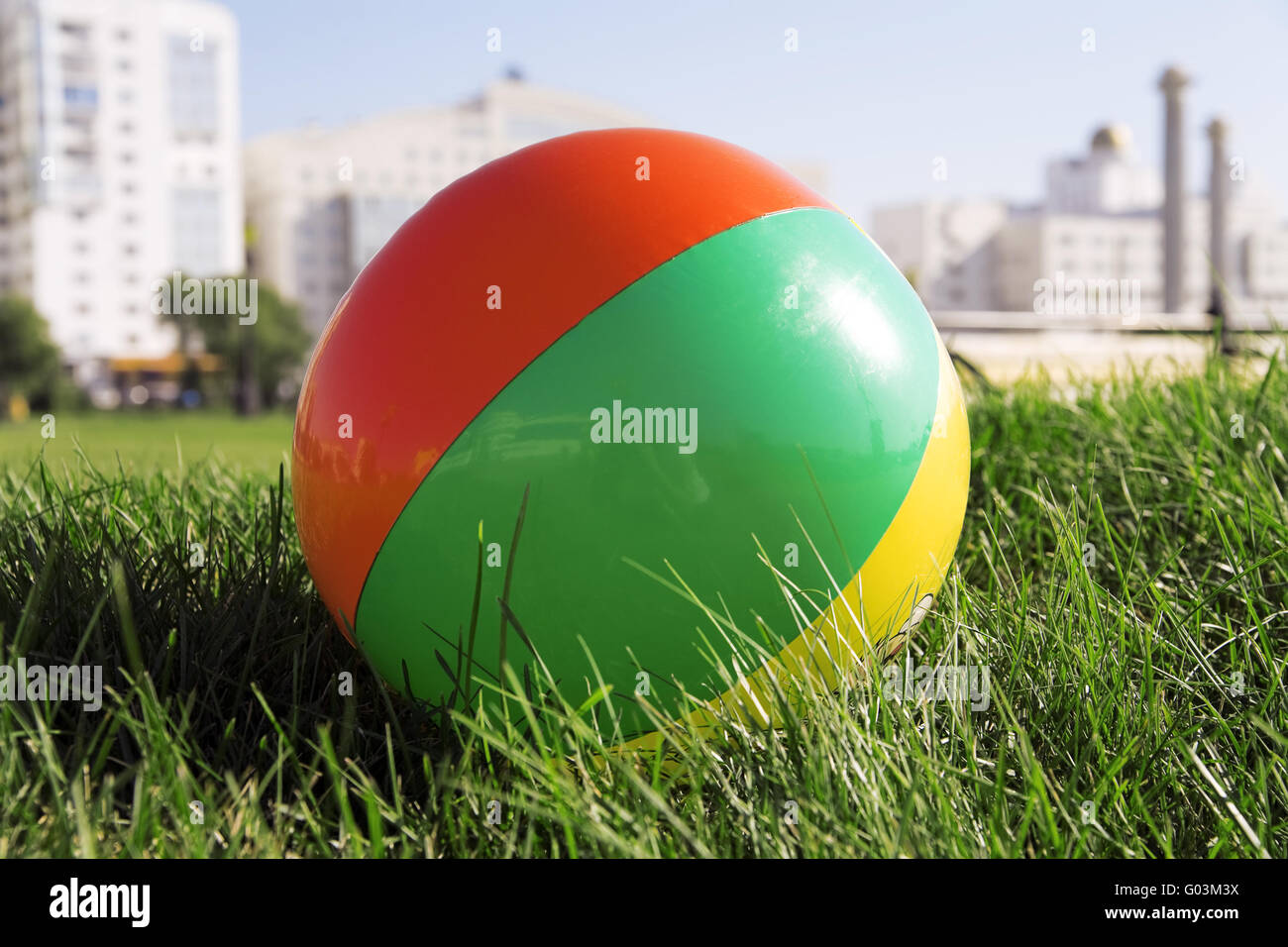 ball for outdoor games lying on grass in city park Stock Photo