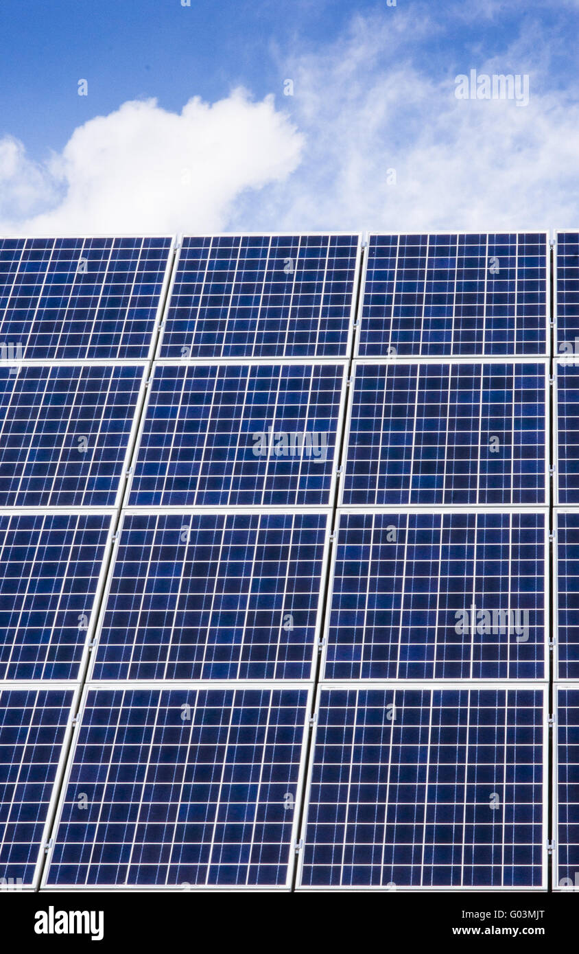 solar panels on a roof, blue sky, white clouds Stock Photo