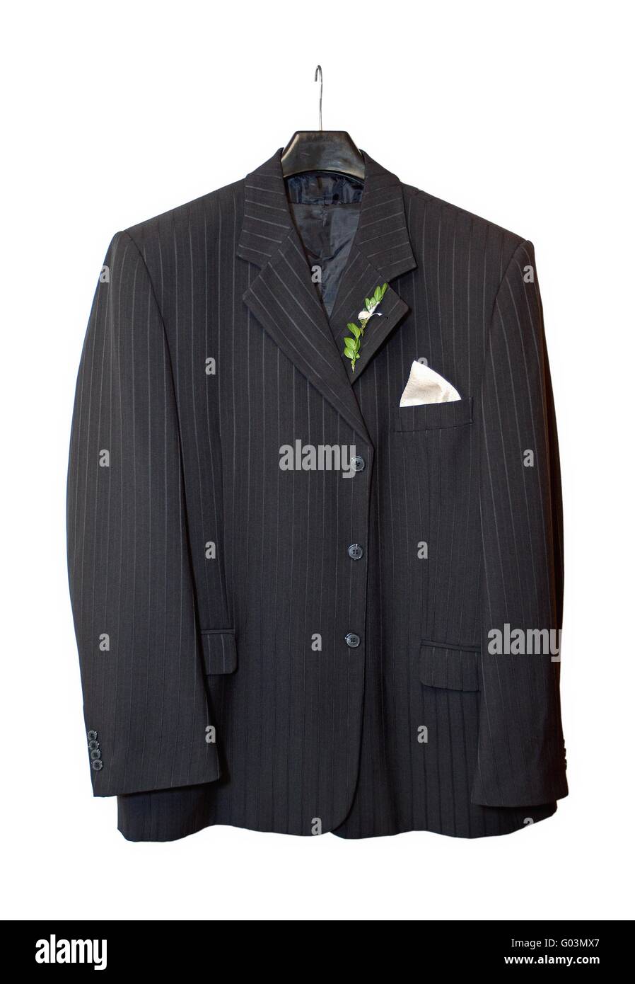 Suit jacket hanging on a hanger with a boutonniere in place on white ...