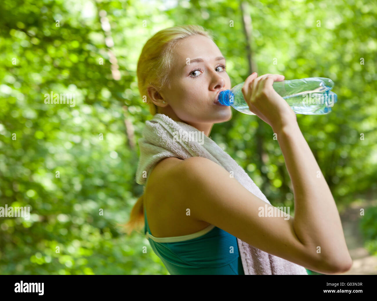Portrait of beautiful smiling woman with bottle of water Stock Photo ...