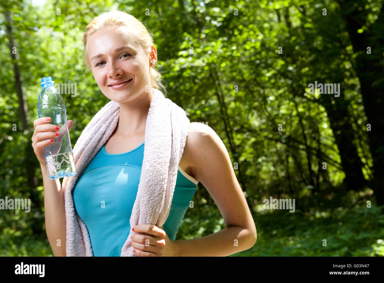 Portrait of beautiful smiling woman with bottle of water Stock Photo ...