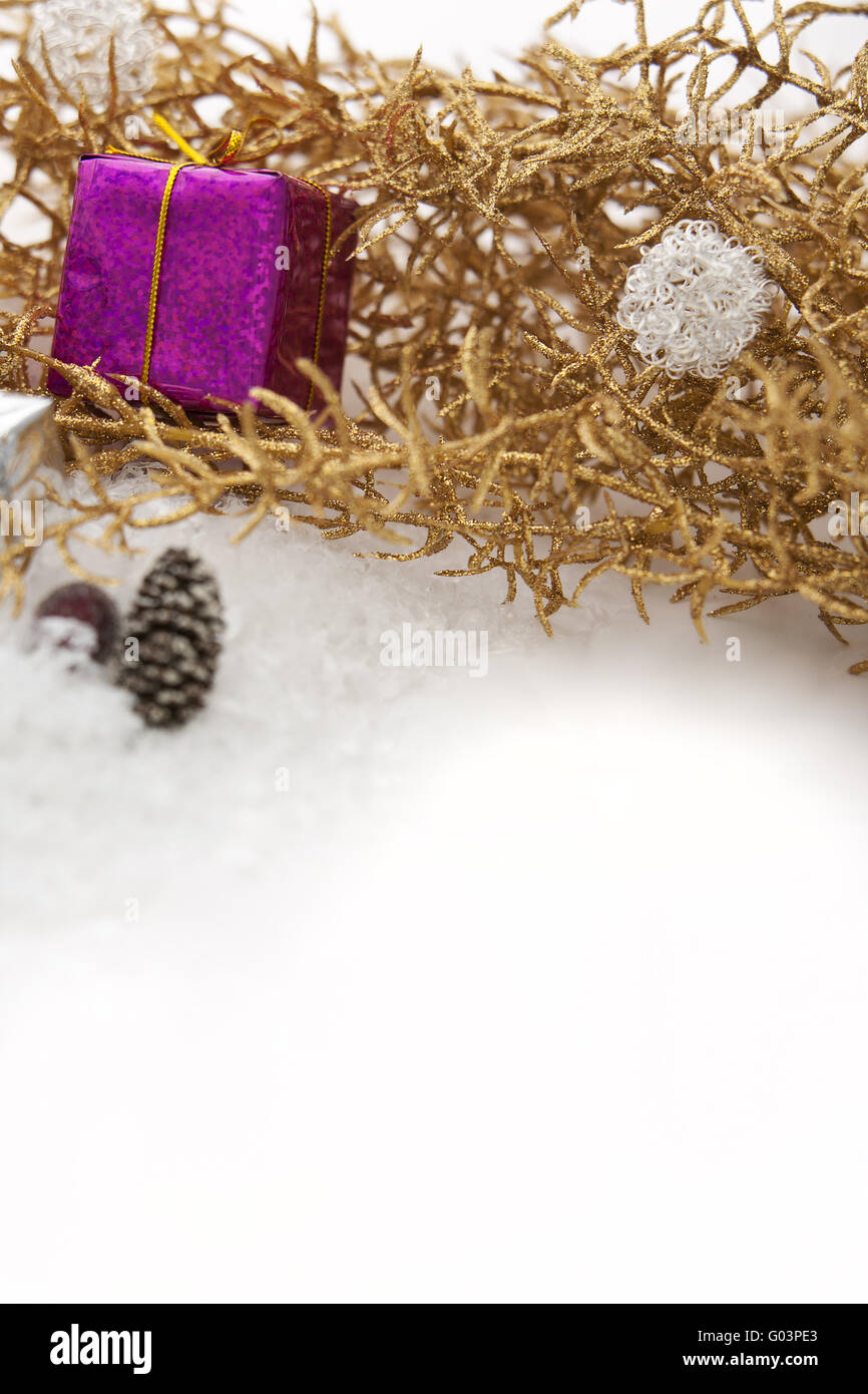 Golden Christmas decorations and gifts with snow Stock Photo