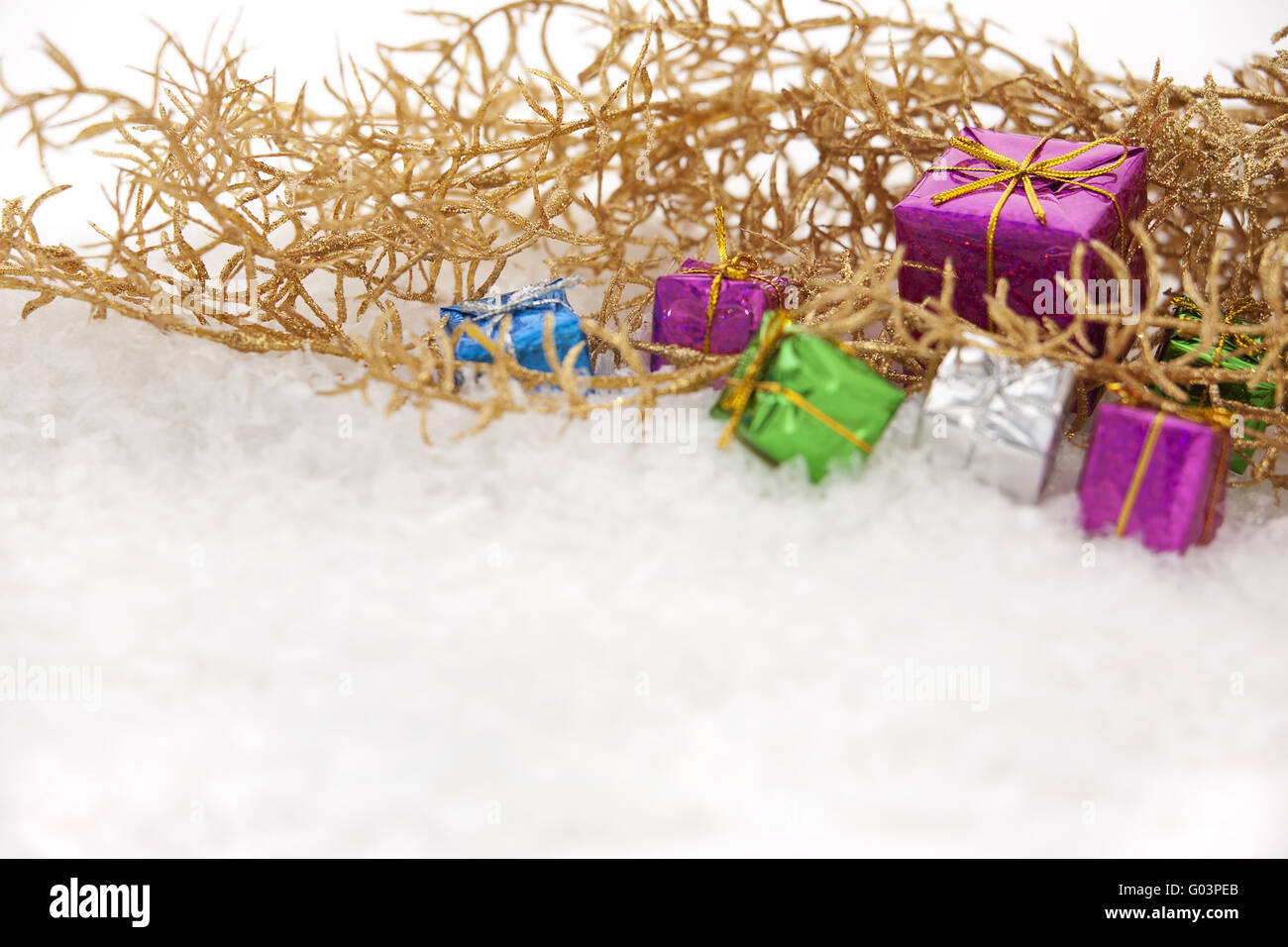 Golden Christmas decorations and gifts with snow Stock Photo