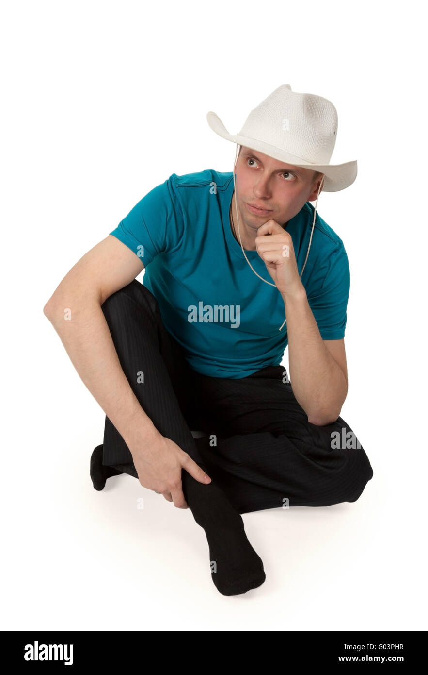 man in a cowboy hat sitting in the lotus position Stock Photo Alamy