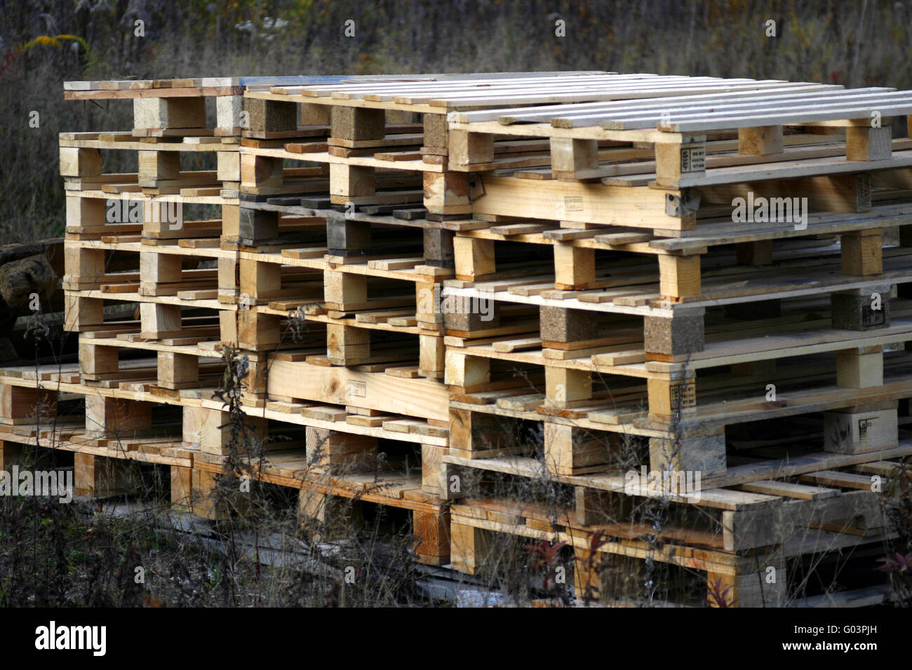 stacked pallets in a meadow Stock Photo