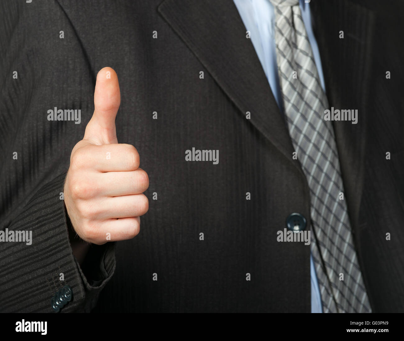 A photo of a hand doing a thumb up gesture Stock Photo