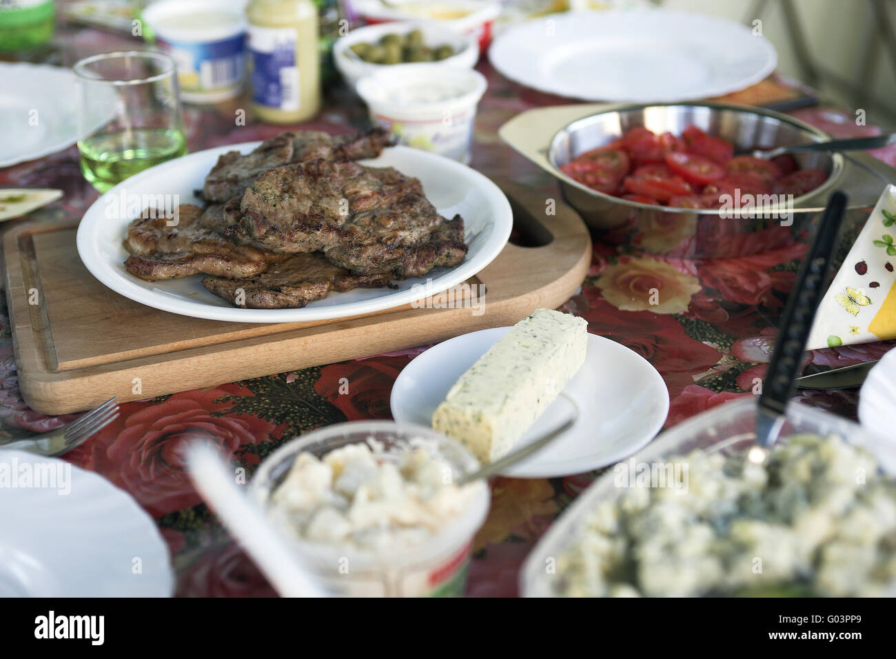 Conservative covered table with grilled meats and Stock Photo