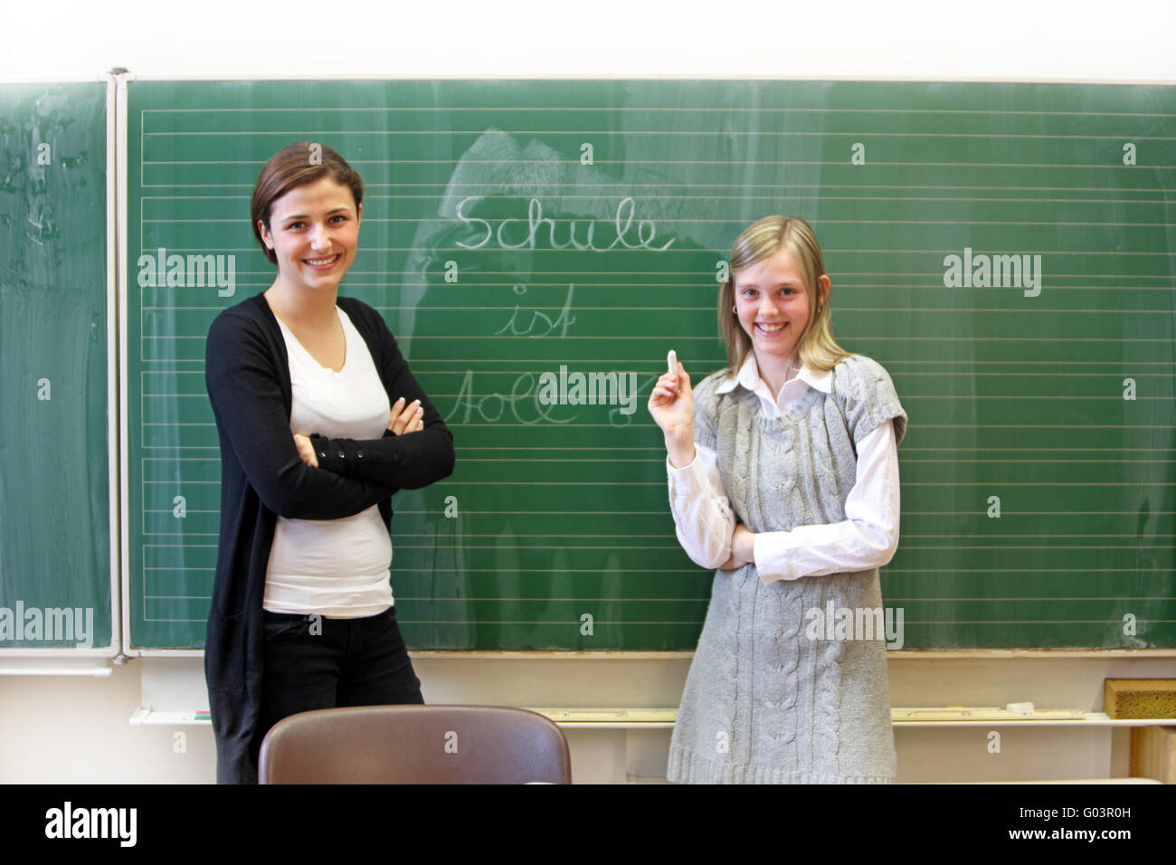 smiling student and teacher in the classroom befor Stock Photo