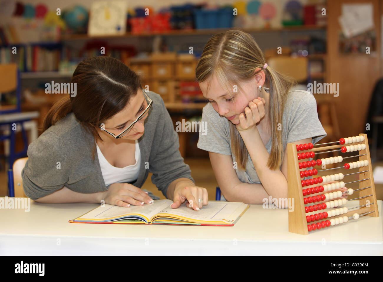 Teacher and student in the school textbook learnin Stock Photo