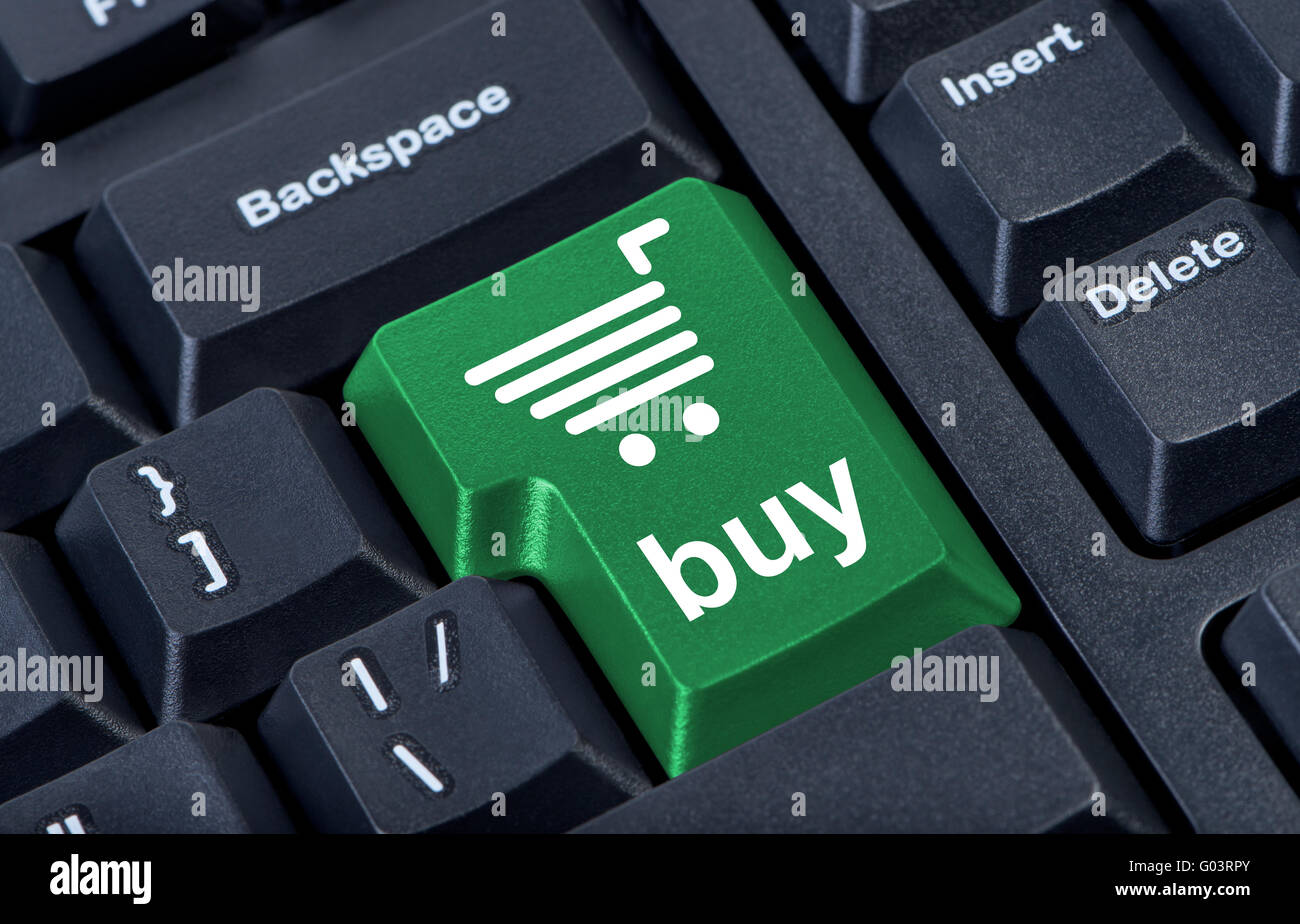 Computer keyboard with green key buy, internet trade concept. Stock Photo