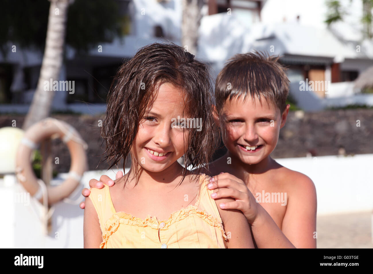 boy and girl playing near pool Stock Photo