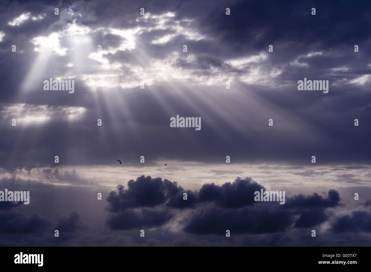 Cloudy stormy sky with sun ray breaking through Stock Photo - Alamy