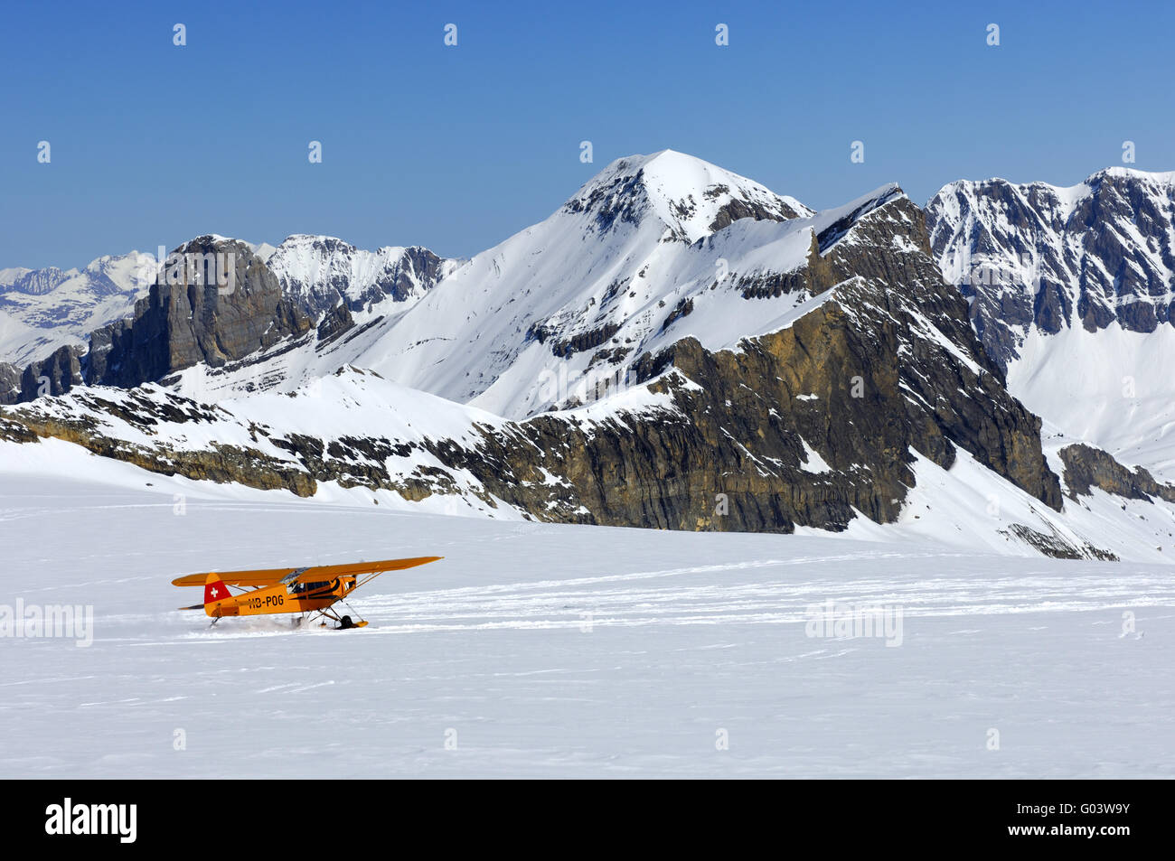 Take-of of a Piper PA-18 Super Cub in the Alps Stock Photo