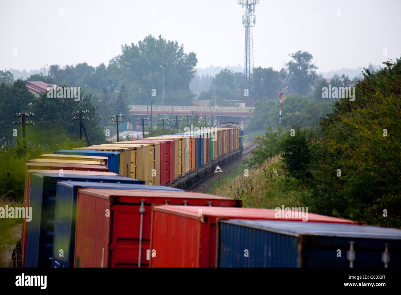 Rural landscape with the container train passing t Stock Photo - Alamy
