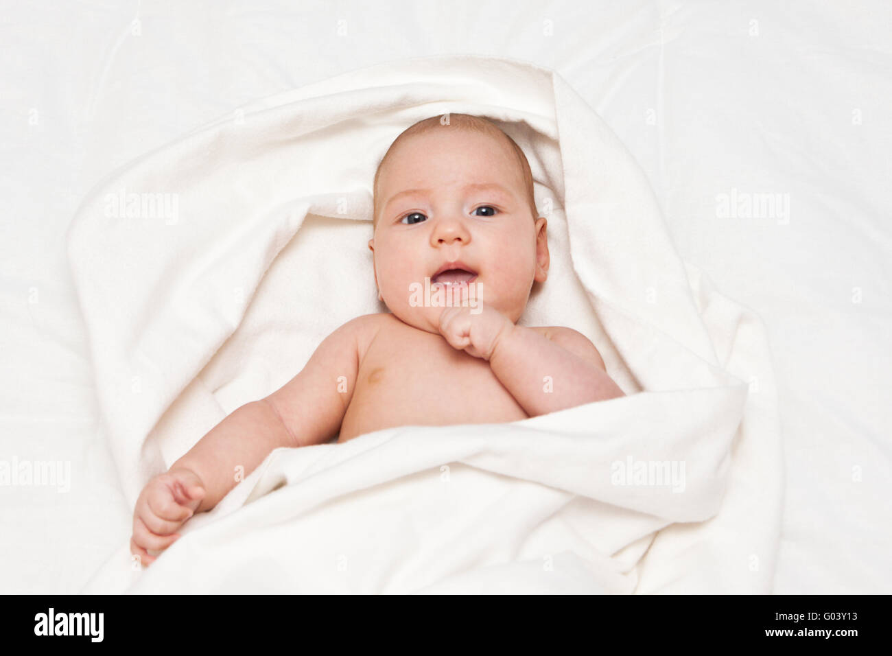 Adorable smiling little girl wrapped in blanket Stock Photo Alamy