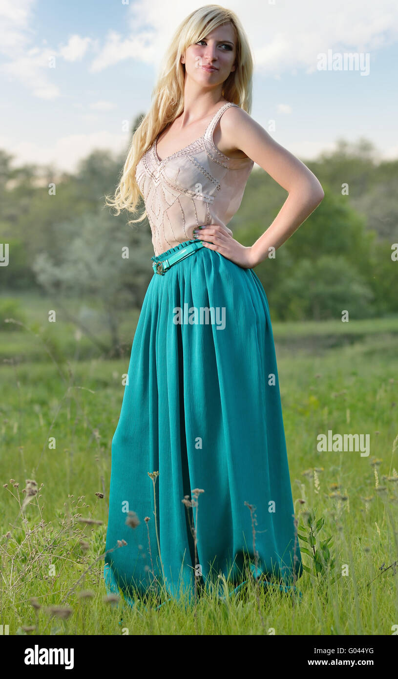 Portrait of pretty girl standing in the field Stock Photo - Alamy