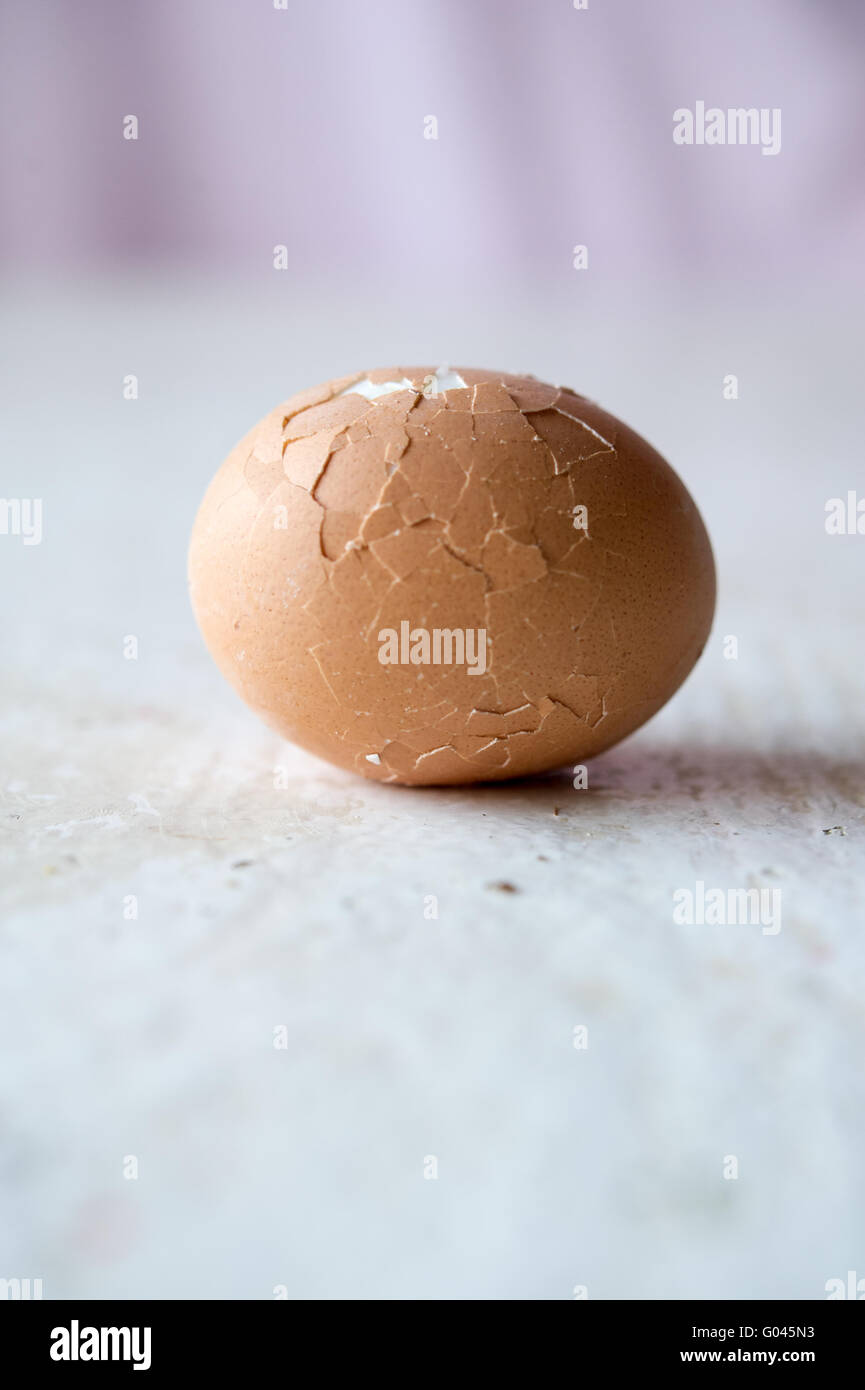 Broken egg on white table Stock Photo - Alamy