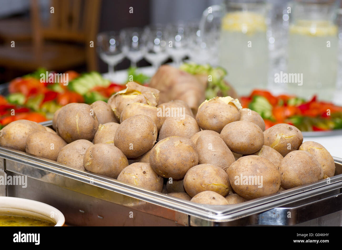 Peel potatoes served in marmites. Lithuanian banquet. Stock Photo