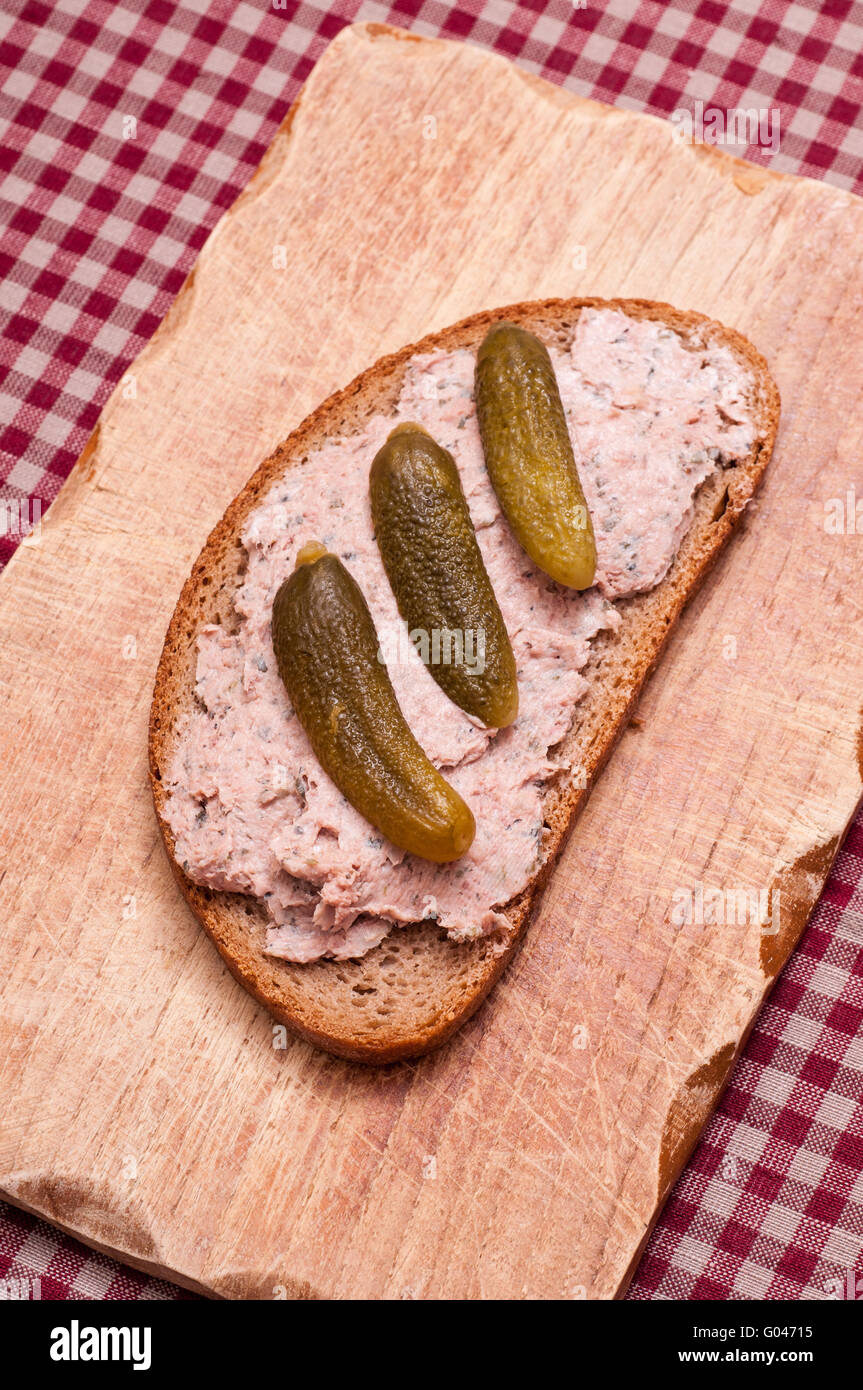 Slice of bread with liver sausage and pickled cucu Stock Photo