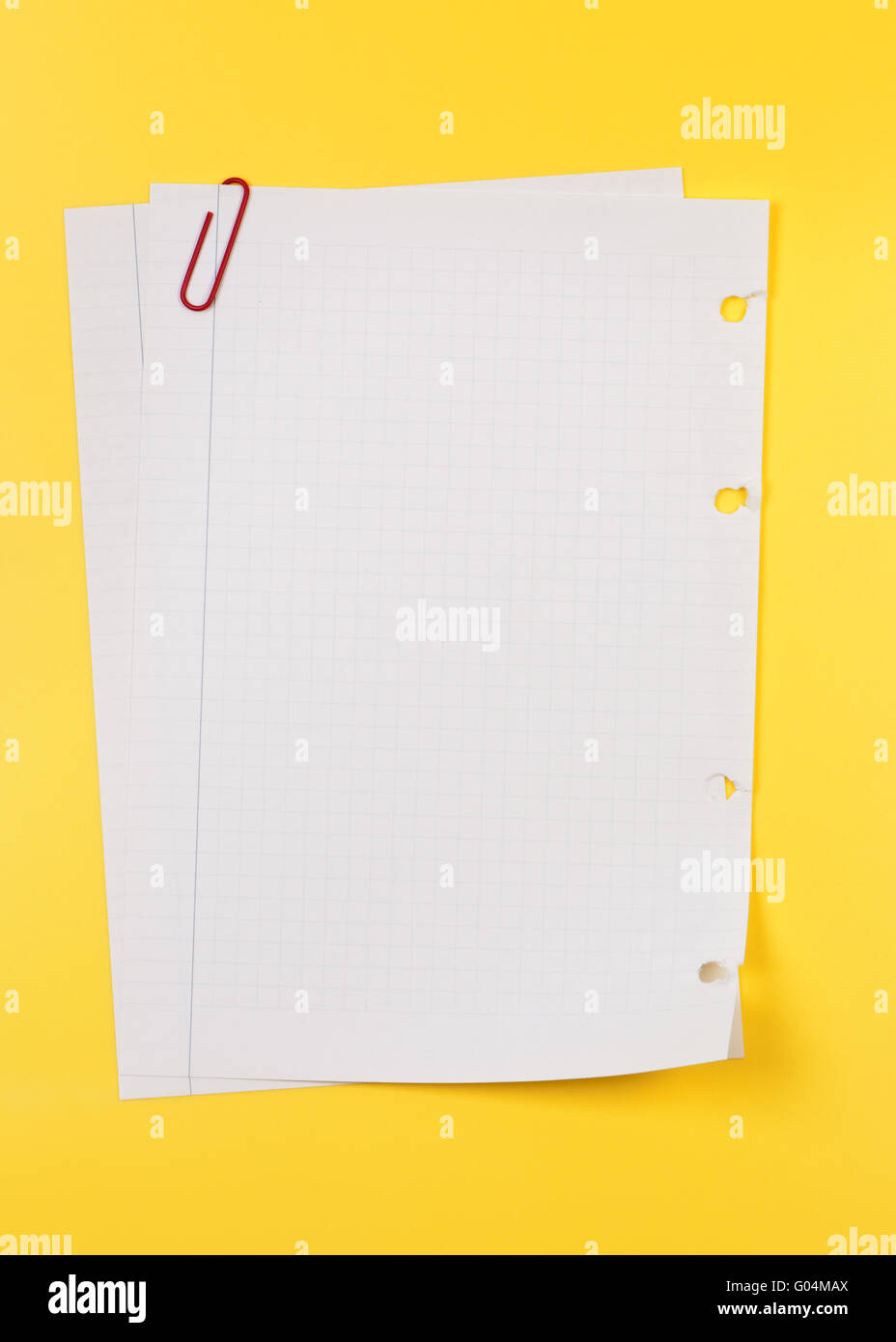 Torn from a notebook sheet held together by paperclip. Stock Photo