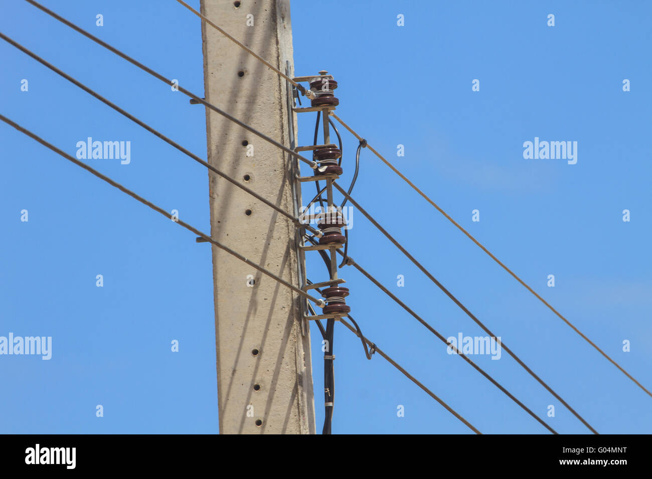 electricity pole on blue sky background in a village Stock Photo