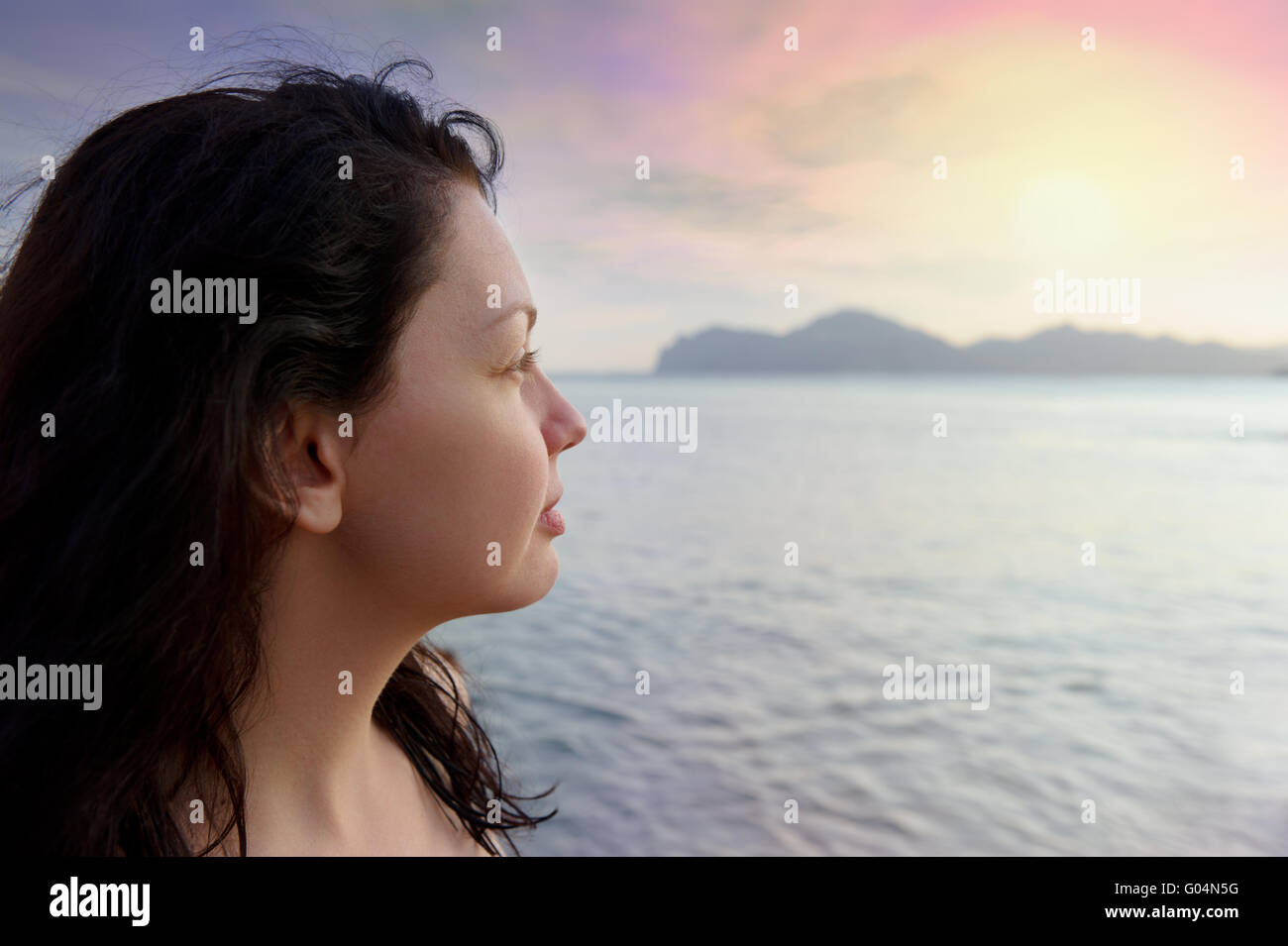 The attractive woman on seacoast and beautiful sunset Stock Photo - Alamy