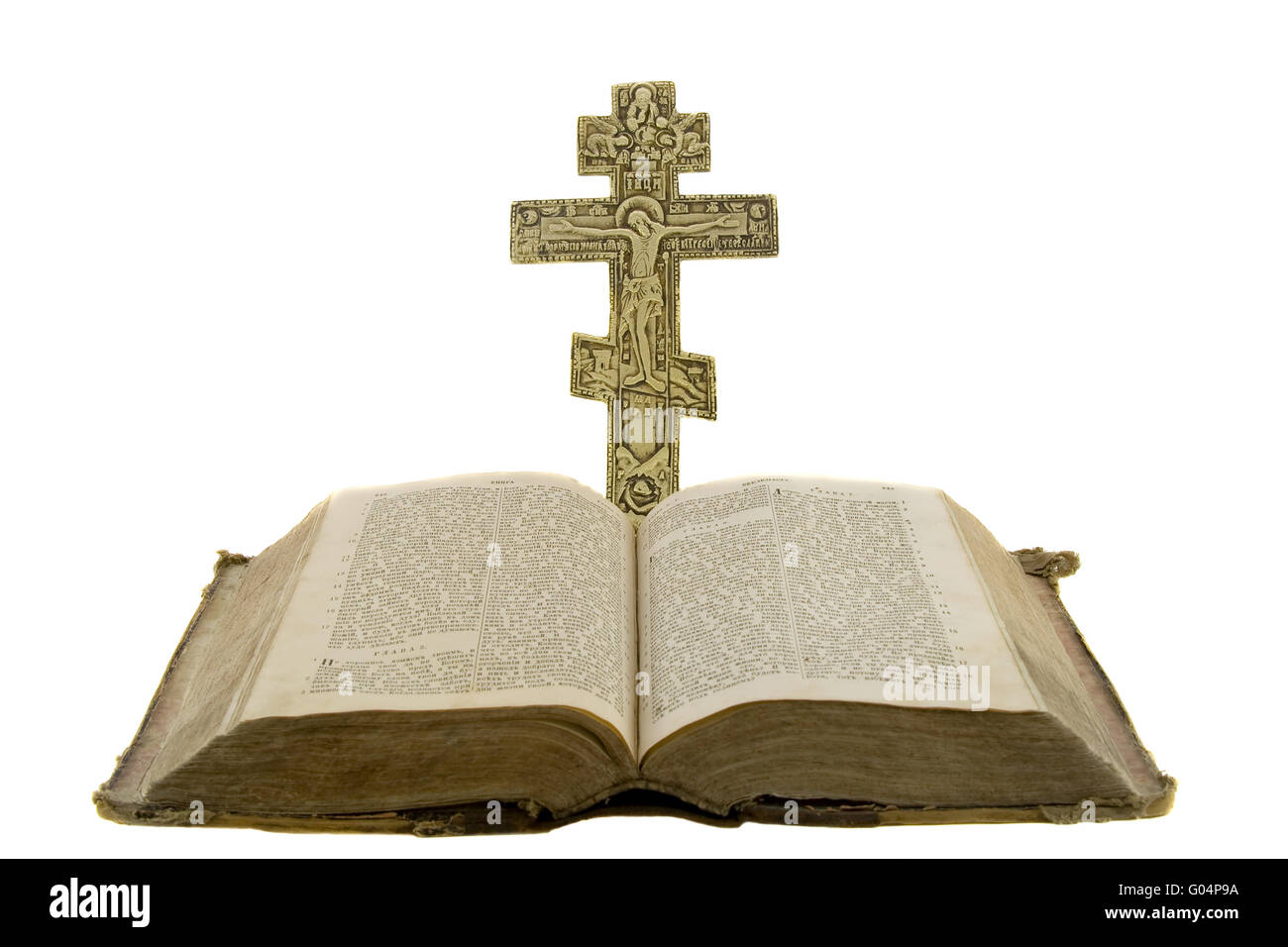 Very old vintage open bible and big church cross near to it isolated over white background Stock Photo
