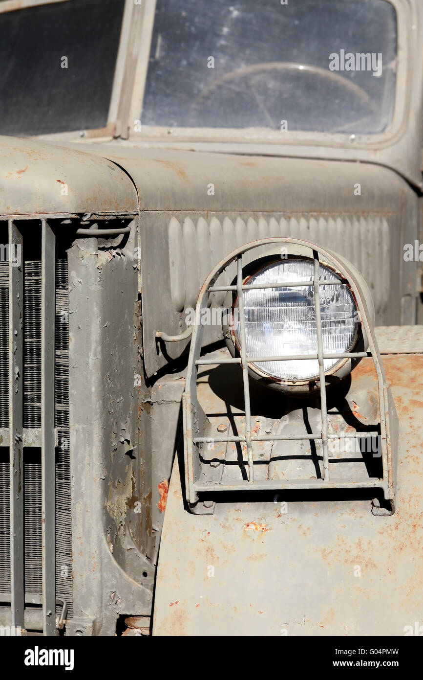 Closeup of old green military truck with headlight in bars Stock Photo